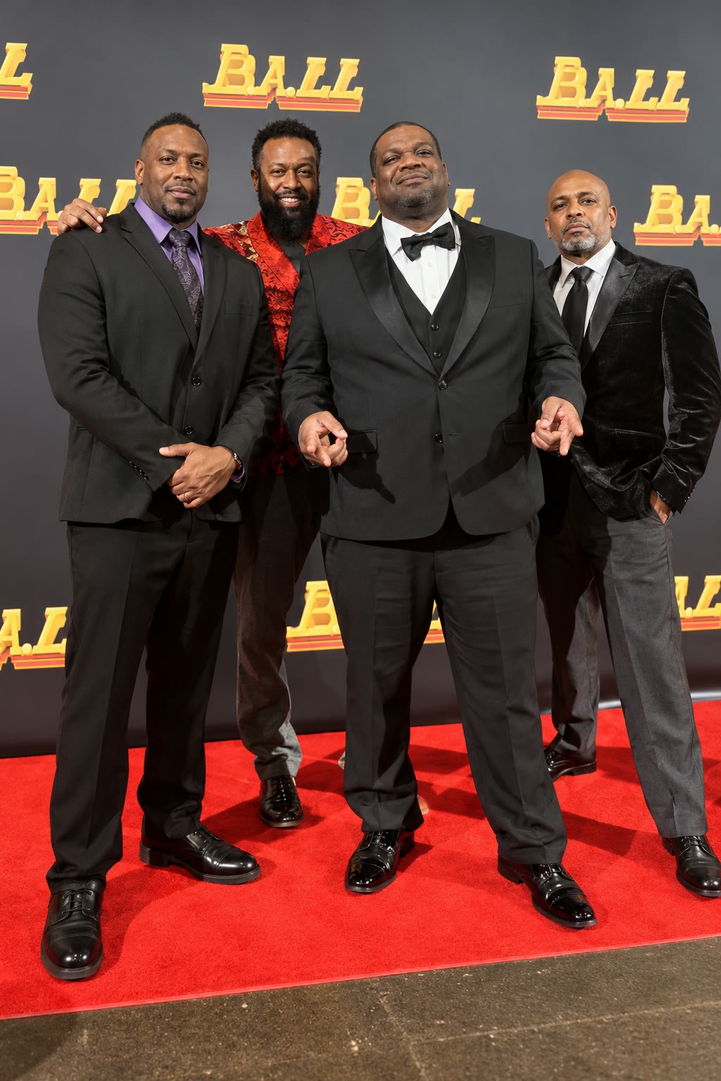 The Space Tunez team in formal attire on a red carpet event step-and-repeat